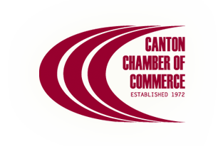 The image displays a logo with text that reads Canton Chamber of Commerce at the top, followed by the word Commerce in a stylized font below the chamber name. Below the main text, there is an additional line of text stating Established 1972. The logo features a curved black and red banner with white lettering and a graphic element resembling a road or pathway in white on a black background. The style of the image is corporate and professional, suggesting that it is likely associated with an official organization or business chamber.